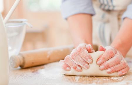 A person kneading bread