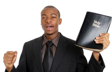 man preaching with a Bible in his hand