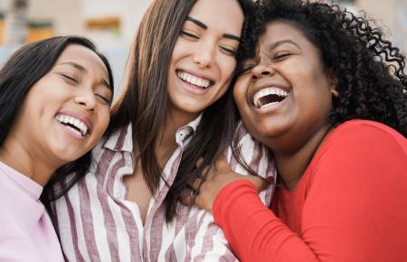 Three friends laughing together