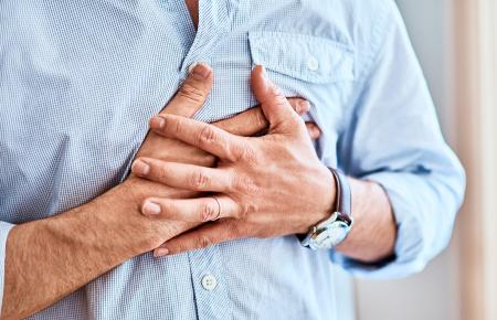 Man gripping his chest
