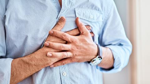 Man gripping his chest