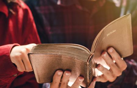 Woman pointing at a Bible