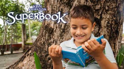 Osman, a young boy in Guatemala City, sits outside, leaning against a tree, reading his children's Bible. The CBN Animation and Superbook logos are stacked in the upper left corner.