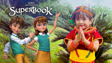 Kia, a 6-year-old girl in Nepal, stands outside holding her hands up to pray. Chris and Joy from Superbook stand behind her to the left, smiling and waving at the viewer. The CBN Animation and Superbook logos are stacked above Chris and Joy.